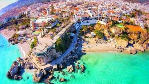 An aerial view of a coastal city with a prominent historical building, a beach, and a rocky shoreline. - Bajamar 13 Nerjarent nice sea and mountain view (Nerja)