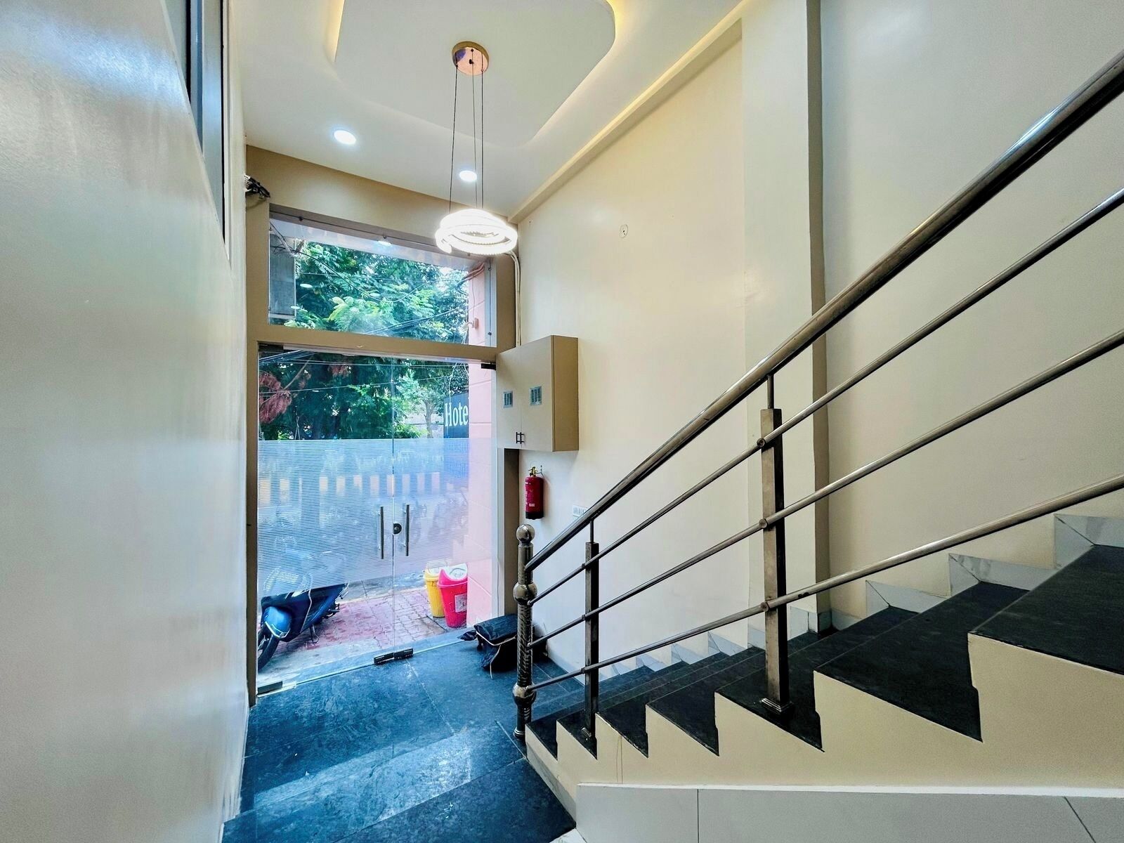 A staircase with a metal railing leading to a landing.