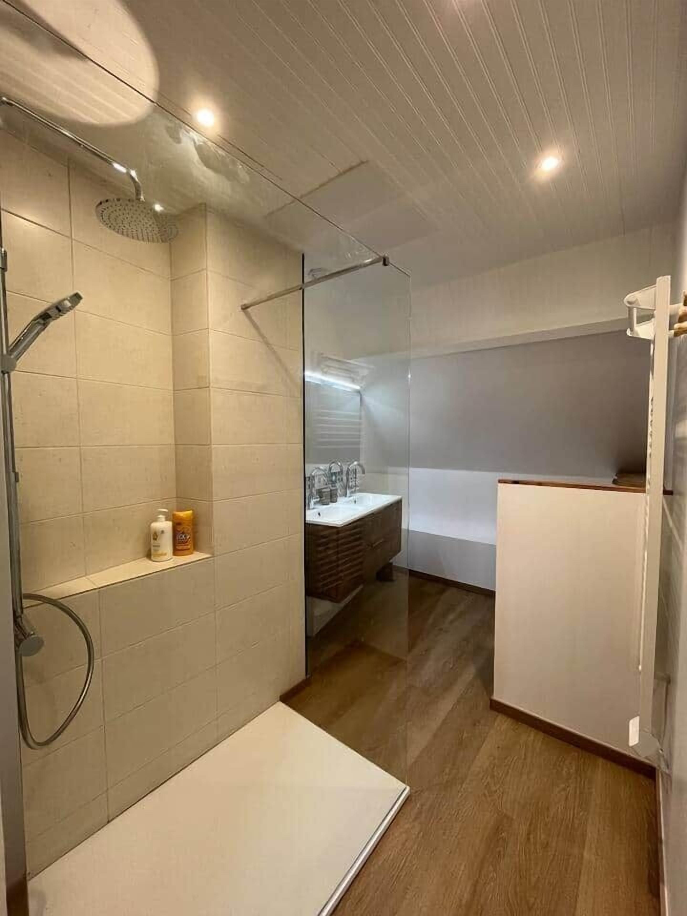 A compact bathroom with a shower, a sink, and a toilet.