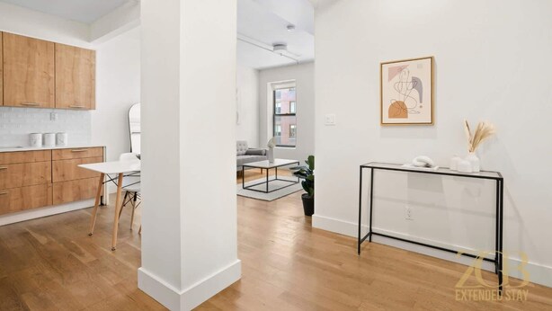 A modern apartment with a kitchen, dining area, and living room. - Renovated 2 Bed 2 Bath Apt in Prime Midtown - Elevator - Laundry (New York)