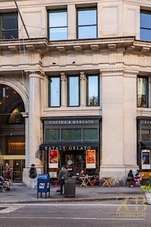A building with a storefront named "Cucina & Mercato" and "Eataly Gelato". - Classic NYC Brownstone 2Br Apartment in Prime Chelsea! (New York)