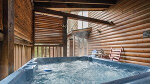 A hot tub with wooden walls and a wooden ceiling.
