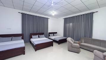 Family Triple Room, Garden View | Desk, laptop workspace, iron/ironing board