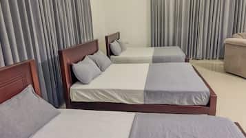 Family Triple Room, Garden View | Desk, laptop workspace, iron/ironing board