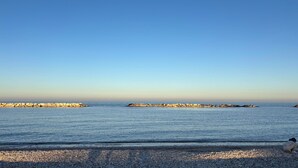 A pebbled beach with a rocky breakwater extending into the sea. - Saxony, close to the Center and the Sea Cozy new apartment (Fano)