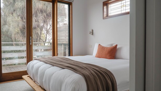 A bedroom with a bed, a window, and a view of trees. - The Chance - Immerse yourself in the oceanic ambience of South Beach. (Port Fairy)