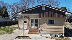 A single-story house with a front porch, a garage, and a small front yard. - 
Welcome to the your budget friendly  stop right off the highway 27. (Somerset)