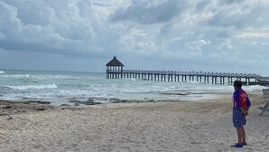 A beach with a pier and a gazebo. - 1BR suite, living room and kitchen in Vidanta Riviera Maya (Playa del Carmen)