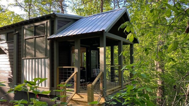 A small wooden cabin with a metal roof, a porch, and a staircase leading to a door. - 2 Homes Mentone Getaway | Riverfront & Near Parks (Mentone)