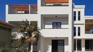 A modern two-story building with a flat roof, large windows, and a balcony. - Nice apartment in Biograd na Moru (Biograd na Moru)
