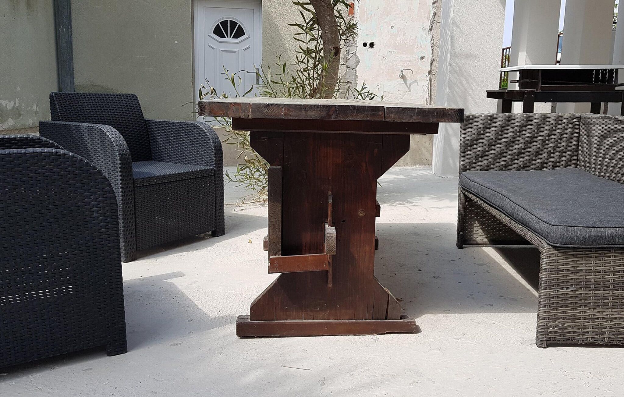 A wicker outdoor seating area with a central table.