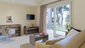 A modern living room with a sofa, a coffee table, a TV, and a sliding glass door to a balcony. - Amazing apartment in Biograd with sauna (Biograd)