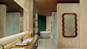 A modern bathroom with a freestanding bathtub, two sinks, a large mirror, and a wooden ceiling.