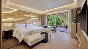 A modern hotel room with a large bed, a small sofa, a TV, and a balcony with a pool. - The Westin Jaipur Kant Kalwar Resort And Spa (Amer)