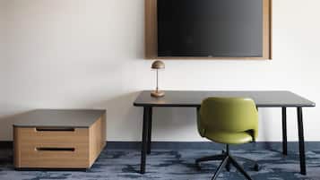 A small, modern workspace with a desk, chair, and a lamp.