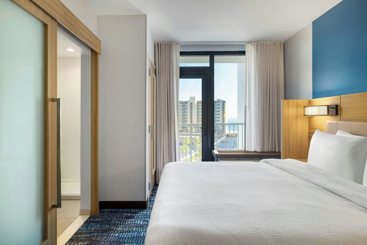 Suite, 1 King Bed with Sofa bed, Balcony, Poolside (View) | Hypo-allergenic bedding, desk, laptop workspace, iron/ironing board