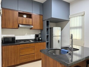 Fridge, microwave, stovetop, coffee/tea maker