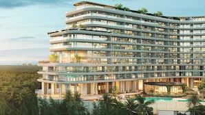 A multi-story hotel with balconies, a swimming pool, and lush greenery. - The St. Regis Costa Mujeres Resort, Cancun (Cancun)