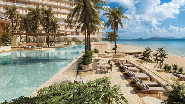 Un resort con piscina, palmeras y vista al mar.