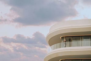 A multi-level building with a curved facade and large windows.