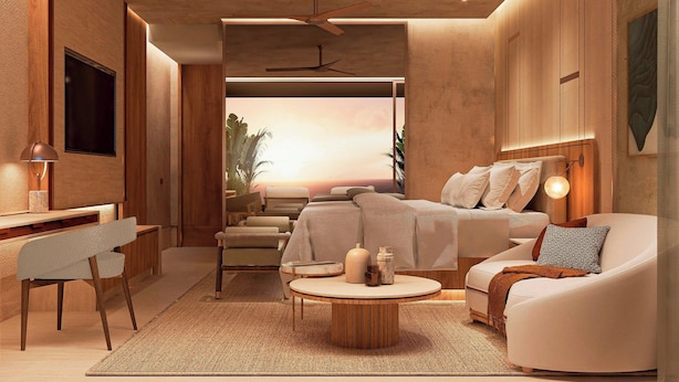 A modern bedroom with a bed, seating area, and a desk. - The St. Regis Costa Mujeres Resort, Cancun (Cancun)