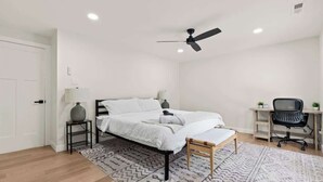 A bedroom with a bed, bedside tables, a desk, a chair, and a ceiling fan. - Off Leash Oasis - Brand New Hot Tub & Fire Pit - Pet Friendly! (Indianapolis)