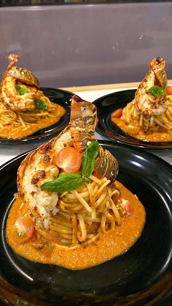 A dish of pasta with clams and a tomato-based sauce.