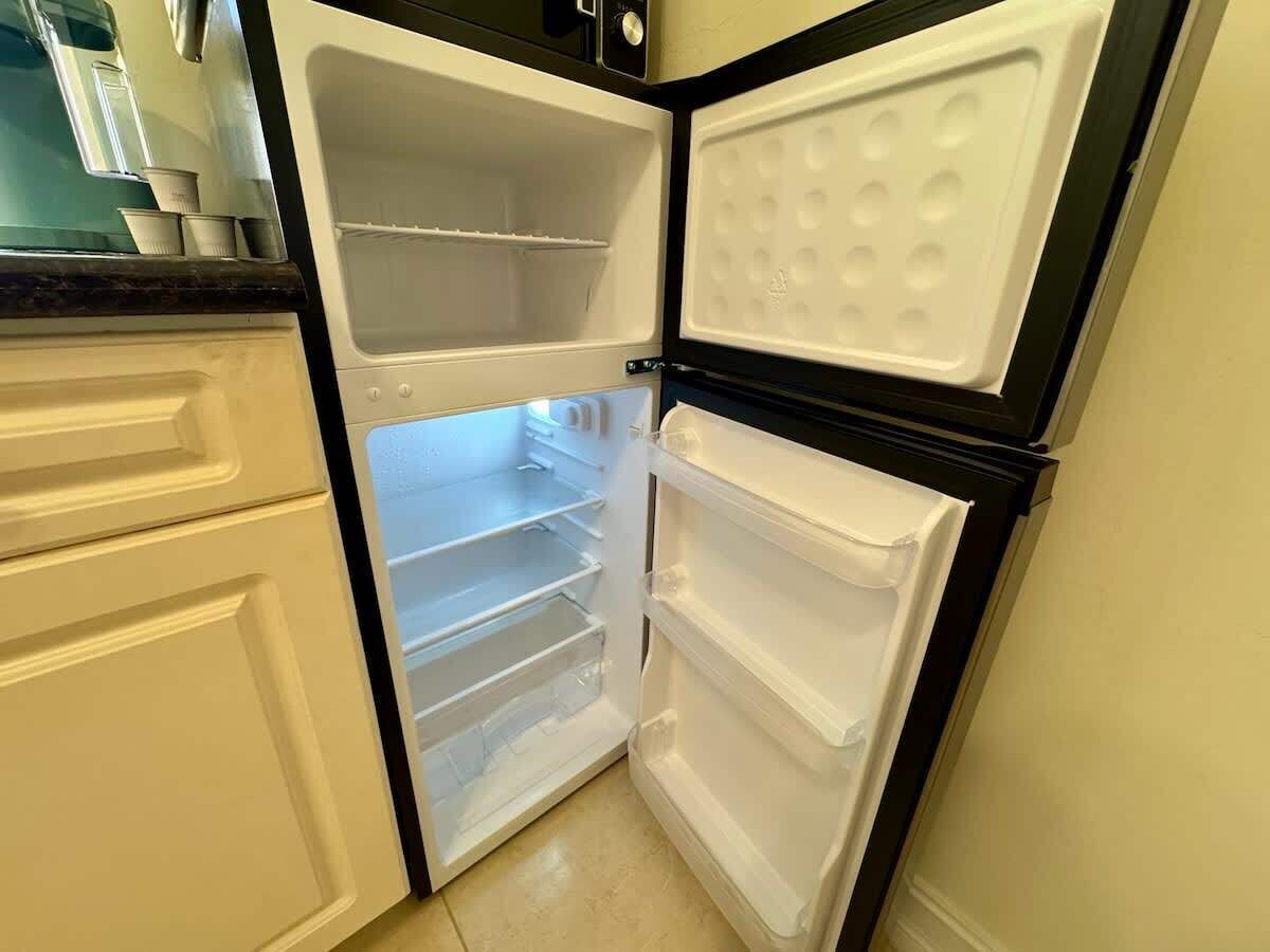 An open refrigerator with multiple shelves and a freezer compartment.