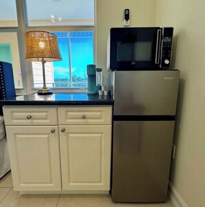 Fridge, microwave, coffee/tea maker, cookware/dishes/utensils