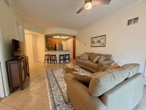 A living room with a sofa, a coffee table, and a TV stand. - Modern Retreat – Beach Gear – Near the Sand (Bonita Springs)