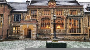 A historic building with stone walls, arched windows, and a prominent coat of arms. - Citylink Central Flat 2 (London)