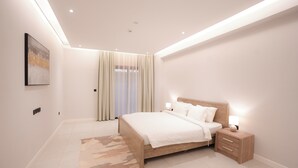 A modern bedroom with a large bed, bedside tables, and a ceiling light fixture. - 2-bedroom apartment in beautiful Riyadh with Full Facilities (Riyadh)