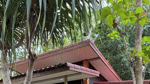 A two-story building with a balcony and a staircase leading to the upper floor. - Lovely 1-bedroom private bungalows at riverside resort with AC and full kitchen. (ตำบล เกาะลันตาใหญ่)