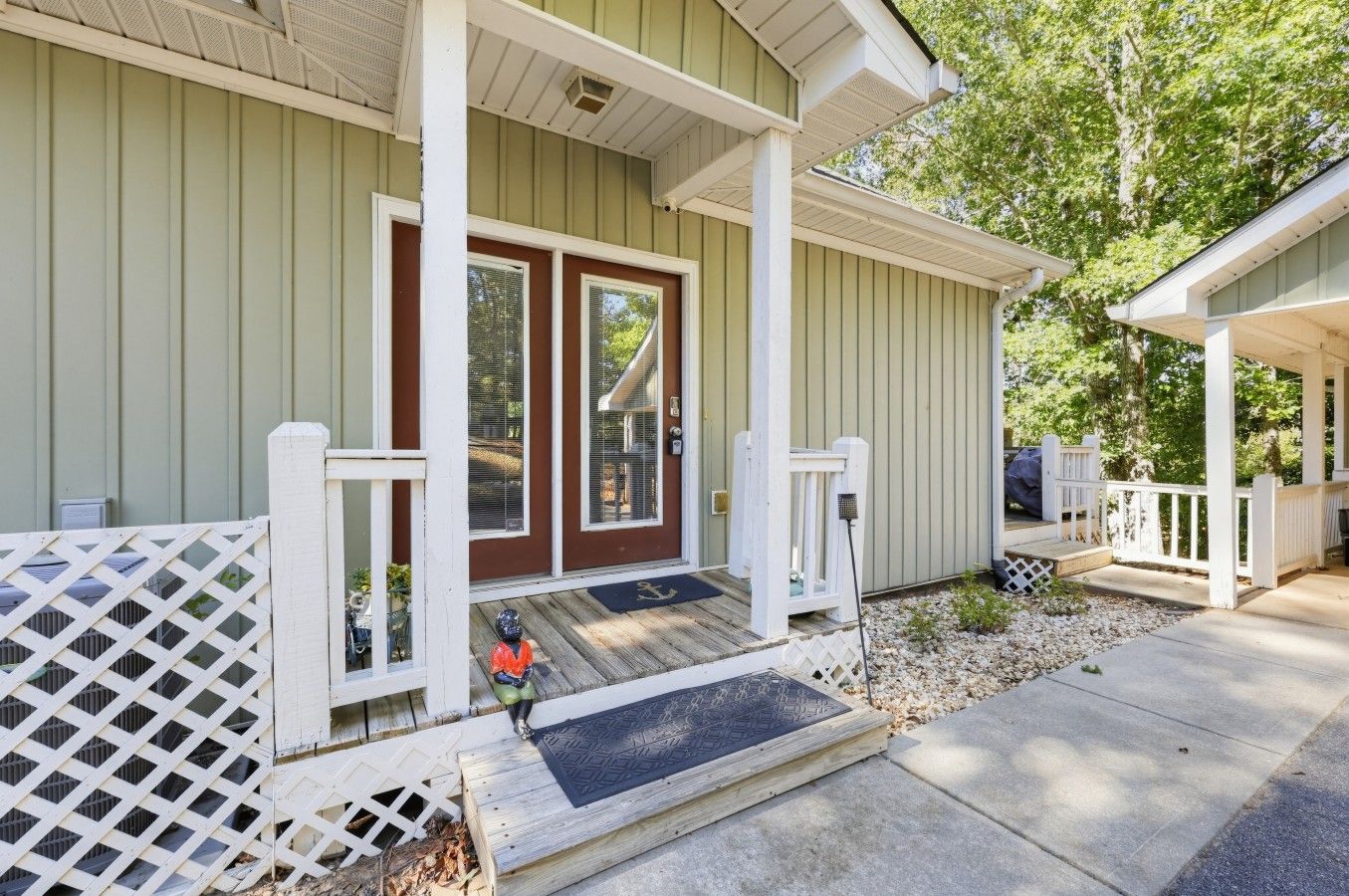A house with a front porch, a covered entryway, and a small deck area.