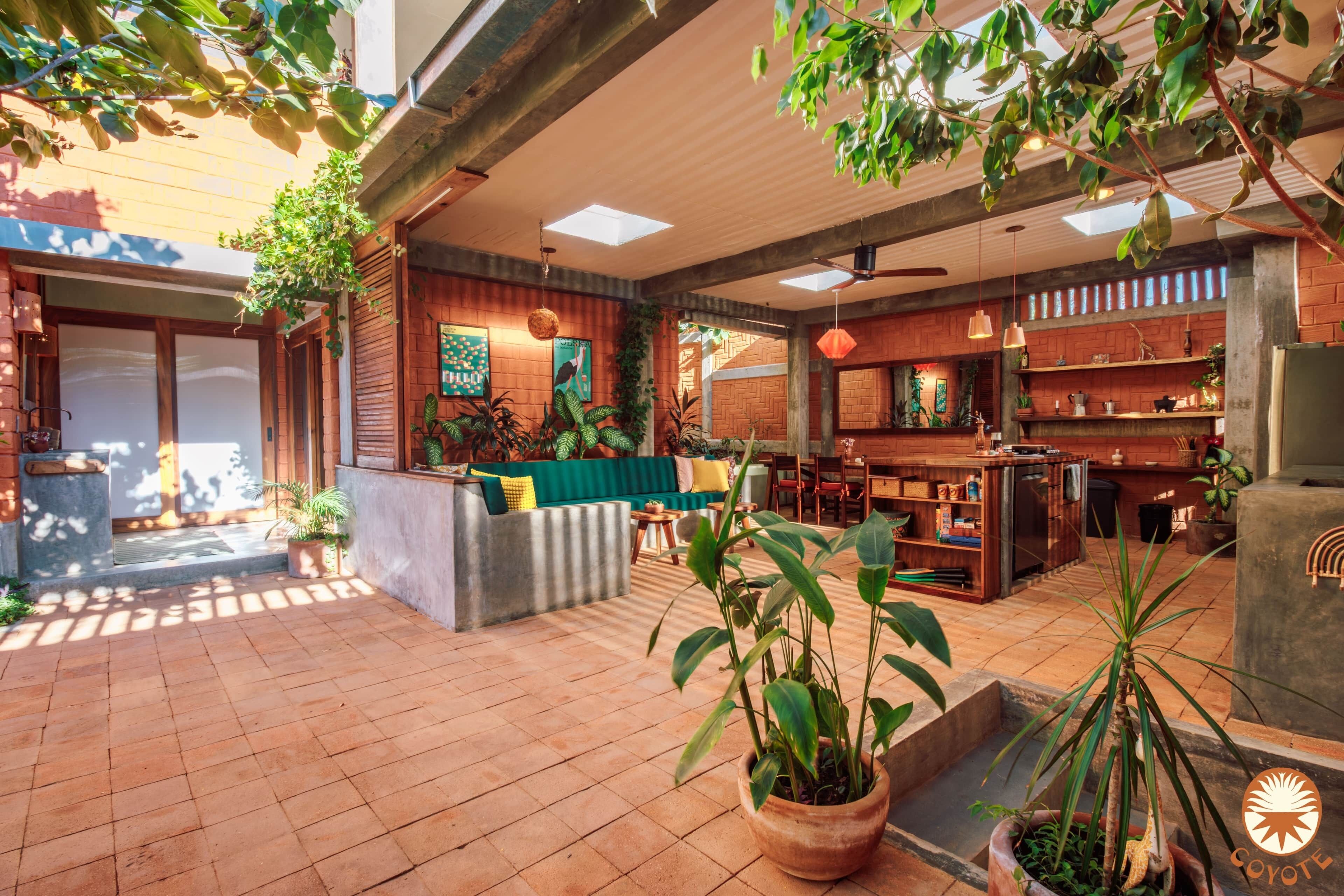 A spacious indoor area with a seating area, a kitchen, and a dining space.
