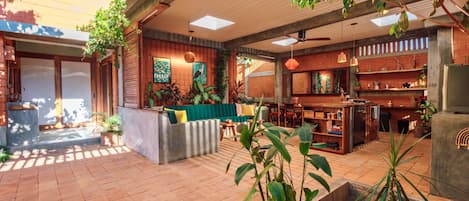 A spacious indoor area with a seating area, a kitchen, and a dining space.
