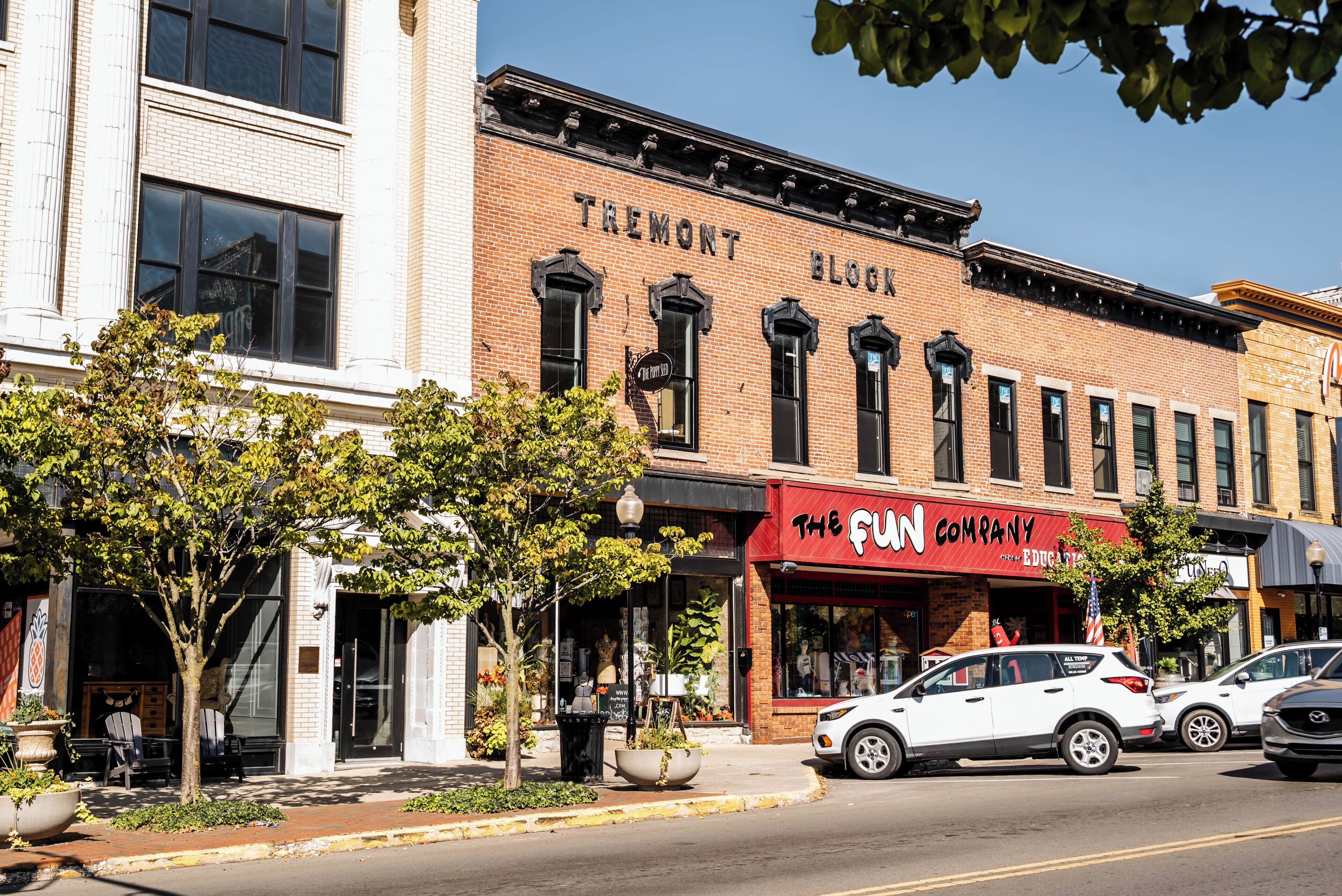 A brick building with a storefront named "The Fun Company."