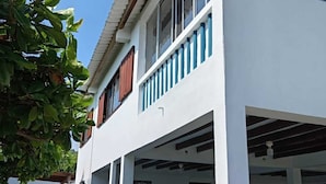A two-story building with a covered parking area and a sign that reads "STAY CHILL".