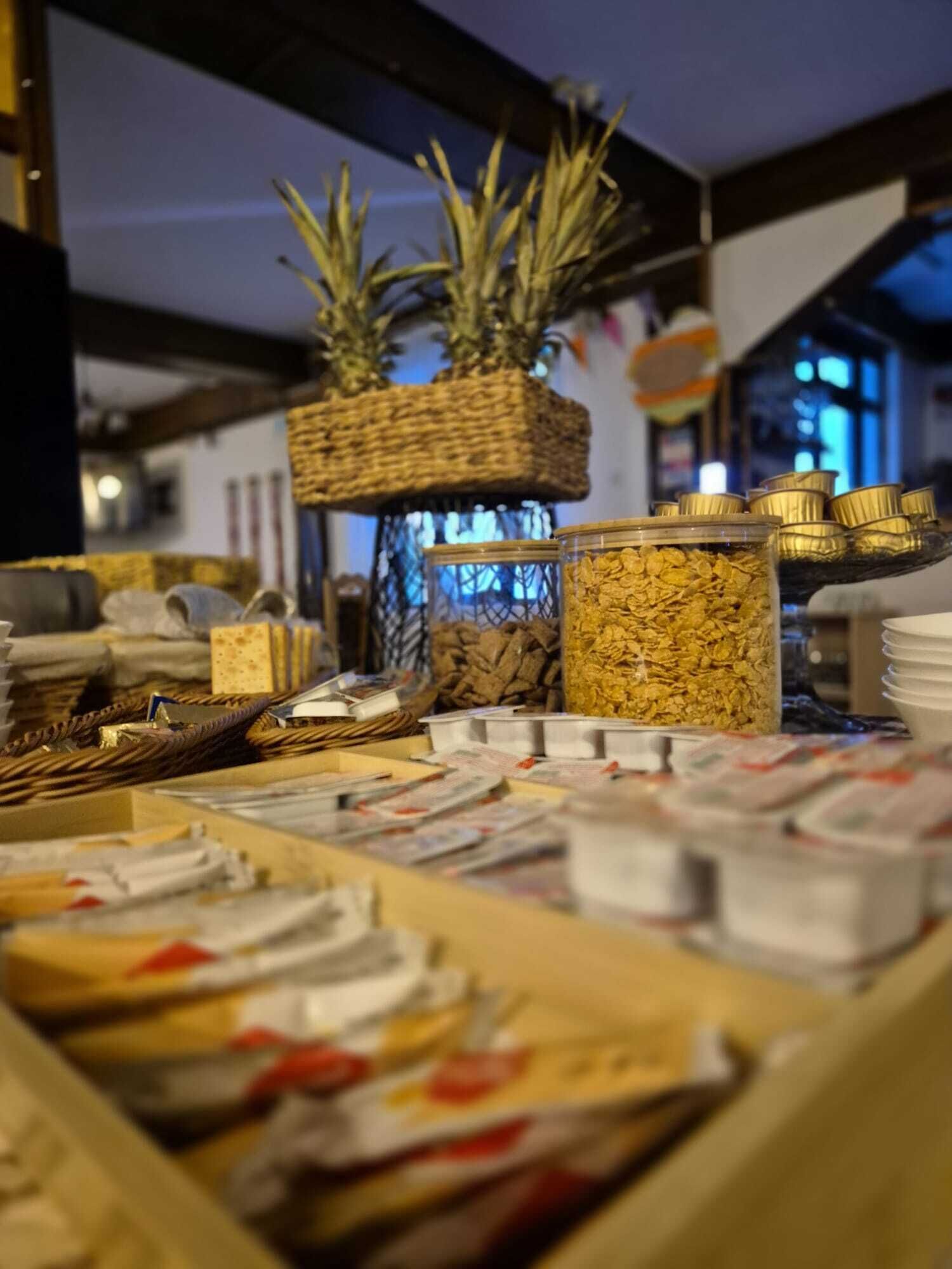 A display of various food items, including jars of cereal and packaged goods, in a store setting.