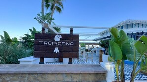 A wooden sign with the name "TROP/CANA" and a swan logo, indicating a hotel or resort. - Carihuela Beach studio, 2nd line of the beach (Torremolinos)