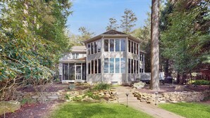 A two-story house with a wrap-around porch, stone retaining walls, and a well-maintained lawn. - Leaf Peeping & Skiing Nearby! Poconos Getaway (Albrightsville)