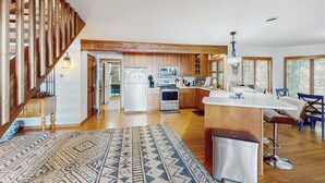 A spacious kitchen with wooden cabinets, a central island, and modern appliances. - Leaf Peeping & Skiing Nearby! Poconos Getaway (Albrightsville)