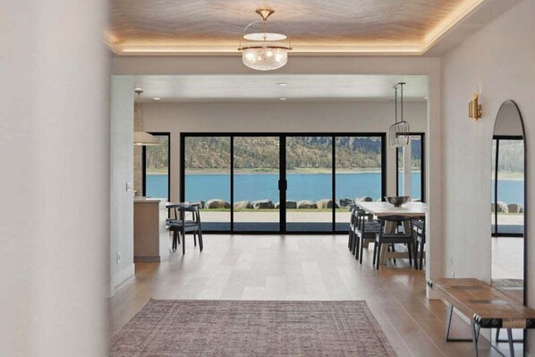 A spacious room with a large sliding glass door leading to a scenic outdoor view.