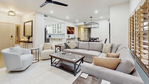 A modern living room with a sofa, armchairs, a coffee table, and a ceiling fan. - Balcony & Pool Access! Extended Stay in Scottsdale (Scottsdale)