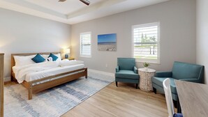 A bedroom with a bed, two chairs, a ceiling fan, and two windows with blinds. - Outdoor Oasis! Group-Friendly Miami Getaway (Miami)