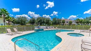 A swimming pool with multiple lanes, sun loungers, and a fenced area. - 17517 Dream (Clermont)