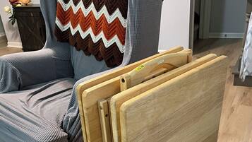 A chair with a wooden frame and a striped fabric seat.