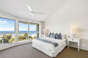 A bedroom with a large window, a ceiling fan, and a bed with pillows. - 8 Andari Sunshine Luxury 1min to Beach (Sunshine Beach)
