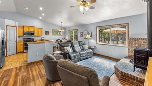 A spacious living area with a kitchen, a fireplace, and a dining area. - Clean comfortable home in quiet neighborhood (McCall)