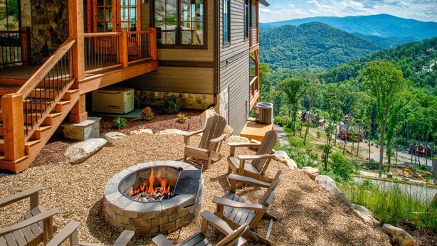 A cabin with a fire pit, outdoor seating, and a scenic mountain view. - Clouds in My Coffee at Eagles Nest- walk to Village amenities, view, hot tub, golden tee arcade (Banner Elk)